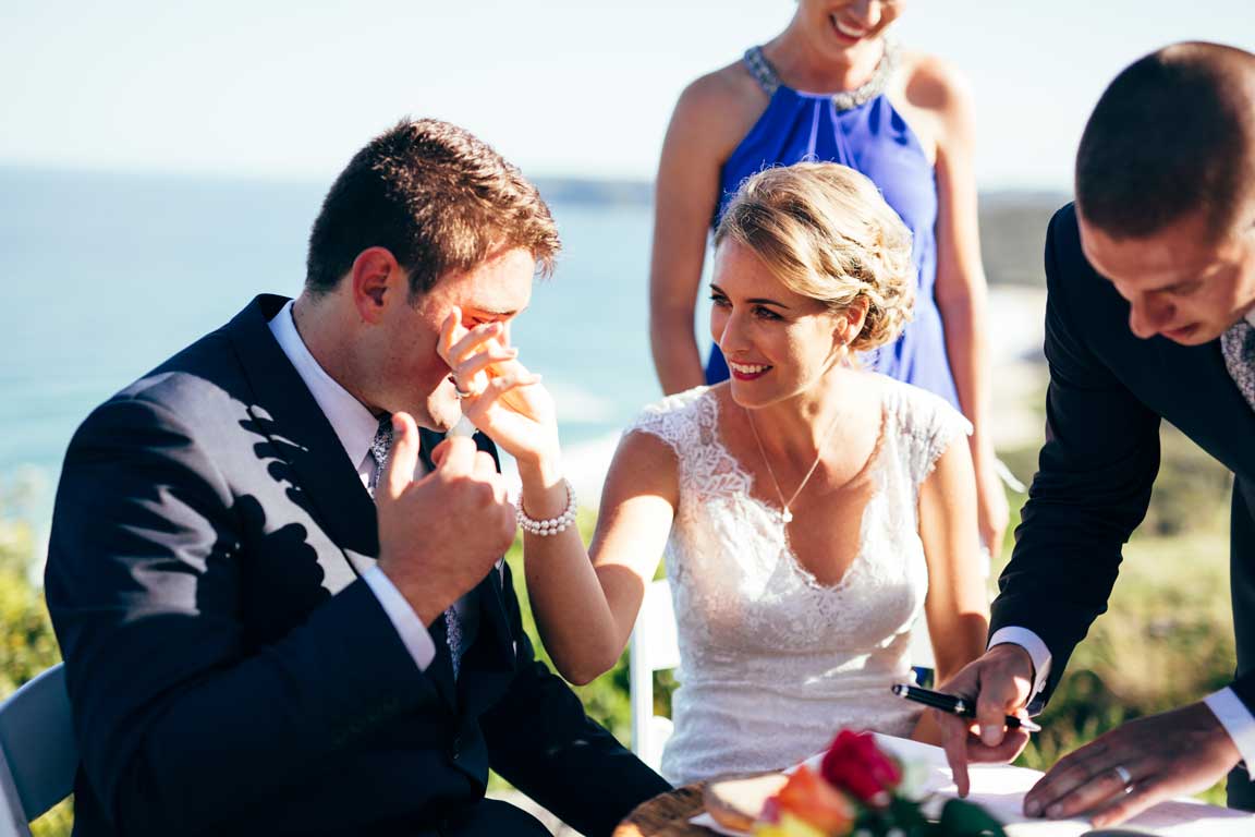 couple signing Certicate of Marriage, grown has a tear in his eye