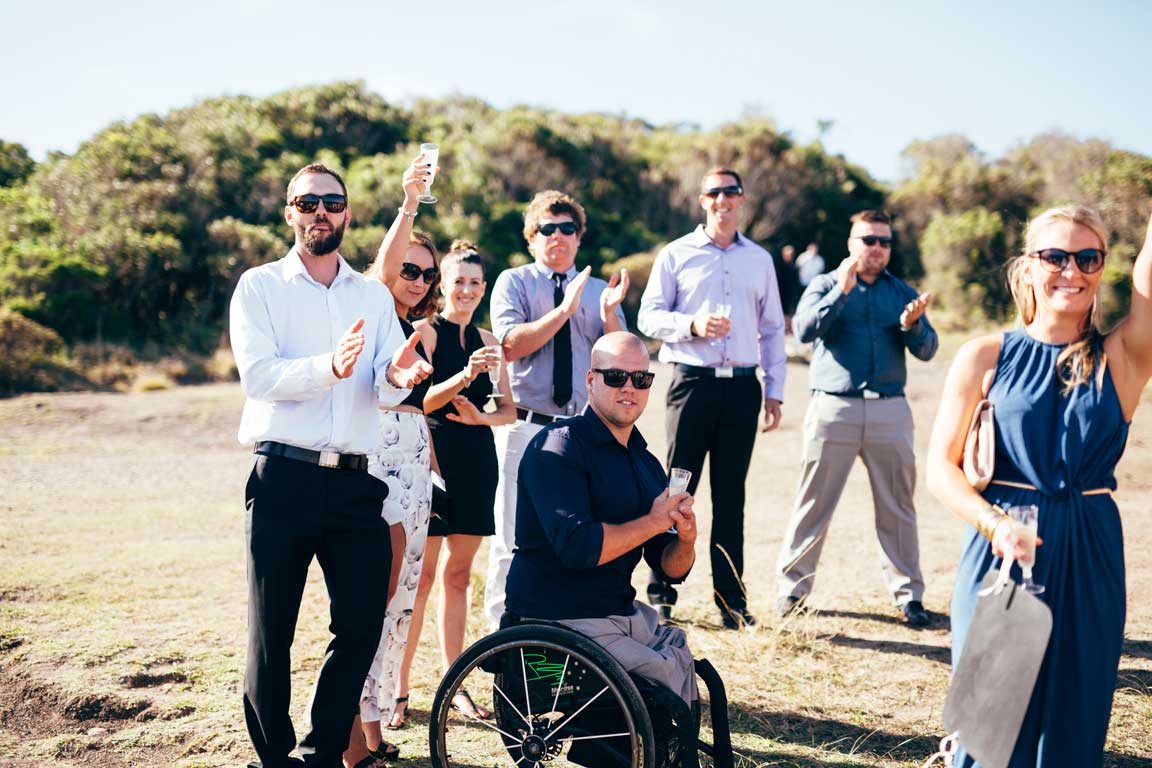 the couples friends cheering with raised arms
